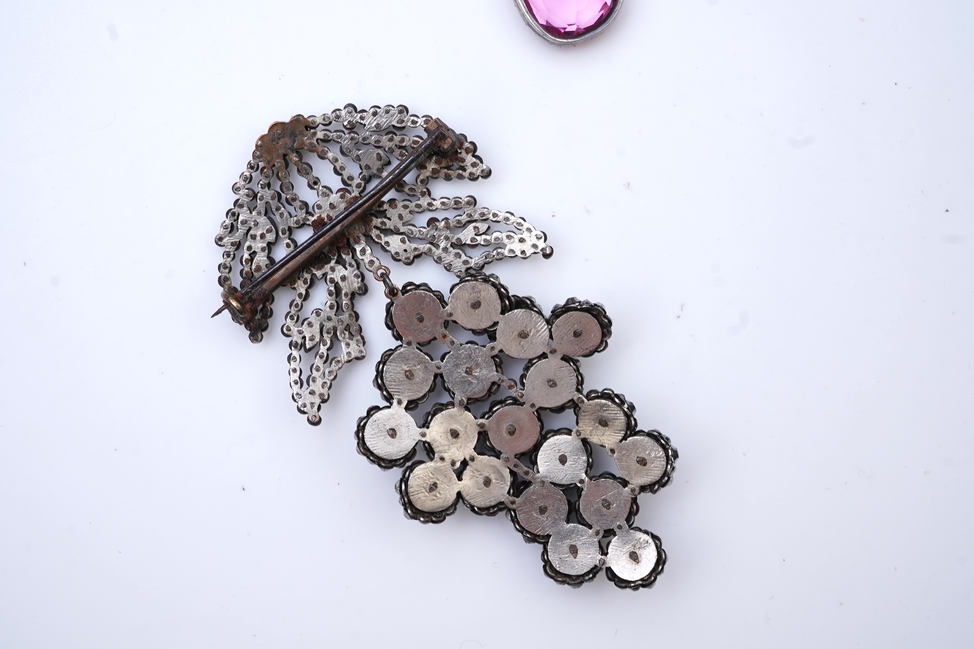 A cut steel brooch, 19th century, and a pink paste pendant